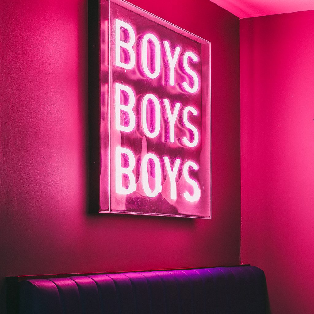 Boys Boys Boys pink neon sign on a pink wall
